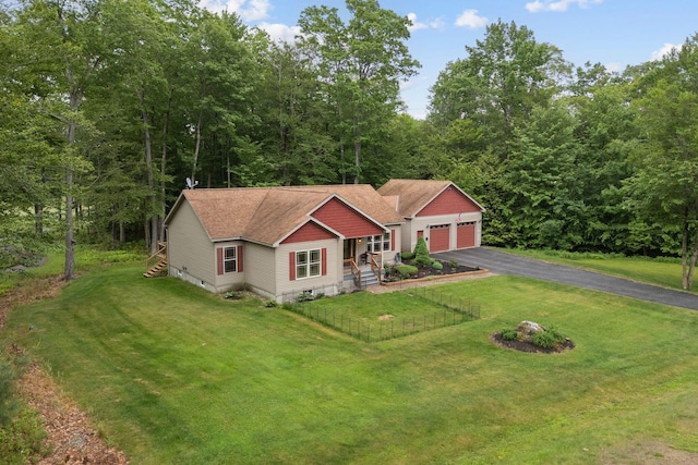31 Knight Way N, Yarmouth, ME 04097 - view of front of house featuring a front yard, asphalt driveway, a shingled roof, and an attached garage