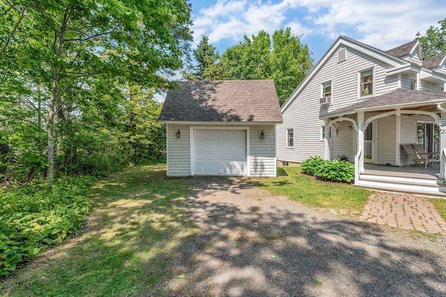 27 Highview Ter, Belfast, ME 04915 - rear view of property with dirt driveway, roof with shingles, an outbuilding, a porch, and a garage