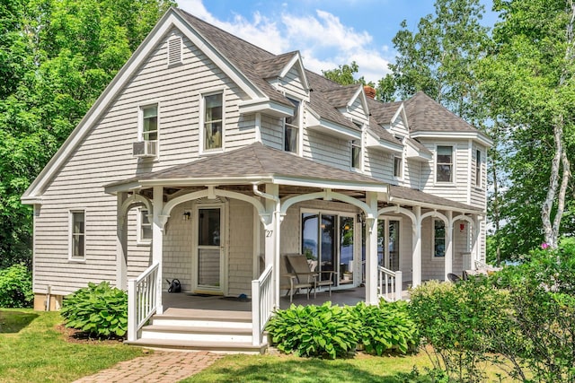 27 Highview Ter, Belfast, ME 04915 - view of front of house featuring a shingled roof, covered porch, cooling unit, and a front lawn