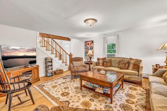 27 Highview Ter, Belfast, ME 04915 - living area with a baseboard heating unit, stairway, and light wood-style floors