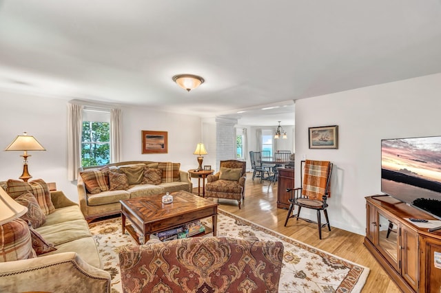 27 Highview Ter, Belfast, ME 04915 - living room with plenty of natural light, light wood-style flooring, and ornate columns