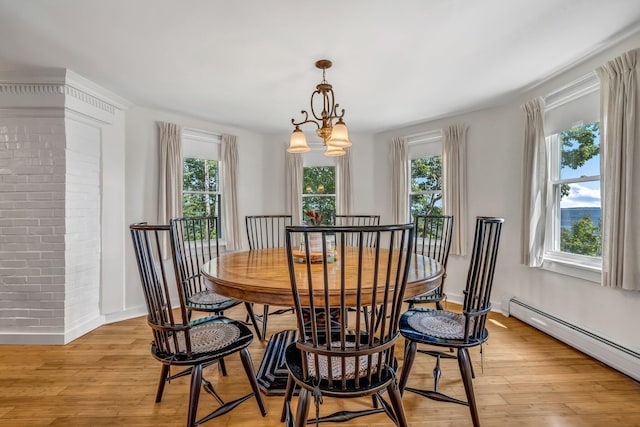 27 Highview Ter, Belfast, ME 04915 - dining space with baseboard heating, plenty of natural light, light wood-style floors, and a chandelier