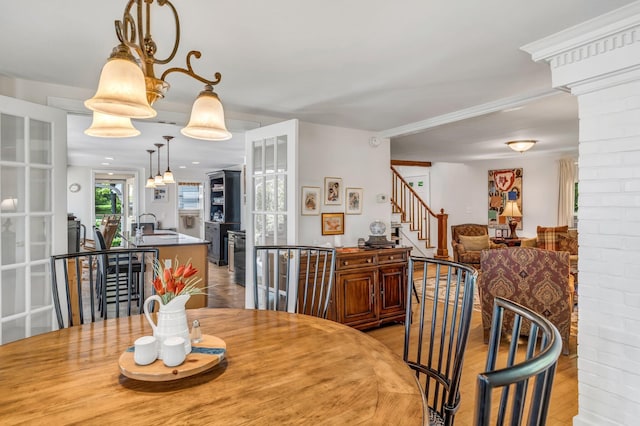 27 Highview Ter, Belfast, ME 04915 - dining area with ornate columns, stairs, and light wood finished floors