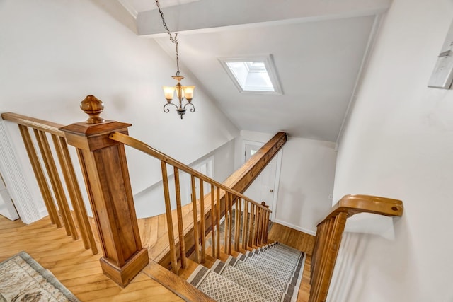 27 Highview Ter, Belfast, ME 04915 - stairway with wood finished floors, a skylight, lofted ceiling, and a chandelier