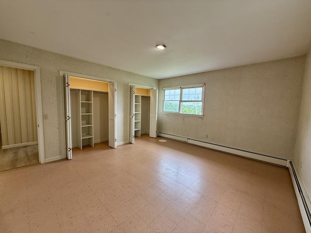 54 Pine Ledge Rd, Bangor, ME 04401 - unfurnished bedroom featuring a baseboard heating unit and two closets