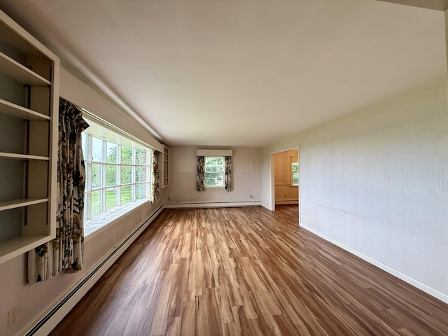 54 Pine Ledge Rd, Bangor, ME 04401 - unfurnished room featuring a baseboard heating unit and wood finished floors