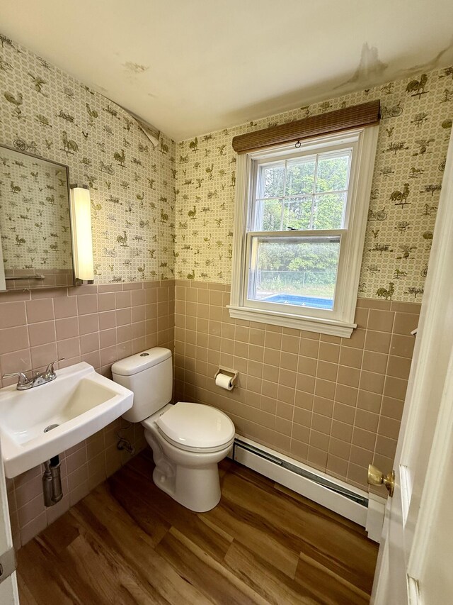 54 Pine Ledge Rd, Bangor, ME 04401 - bathroom featuring baseboard heating, tile walls, wallpapered walls, a wainscoted wall, and wood finished floors