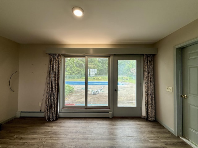 54 Pine Ledge Rd, Bangor, ME 04401 - empty room with wood finished floors and a baseboard heating unit