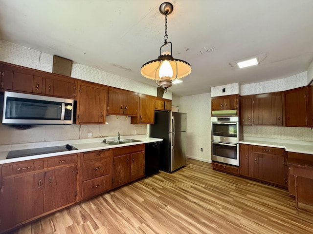 54 Pine Ledge Rd, Bangor, ME 04401 - kitchen with black appliances, light wood-type flooring, light countertops, pendant lighting, and wallpapered walls