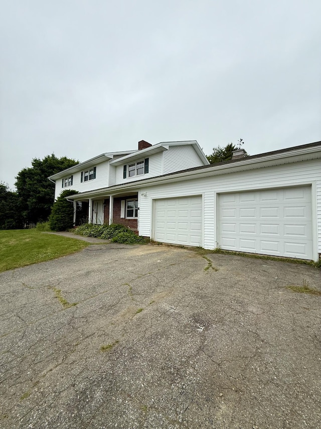 54 Pine Ledge Rd, Bangor, ME 04401 - traditional-style home featuring asphalt driveway, a garage, and a chimney