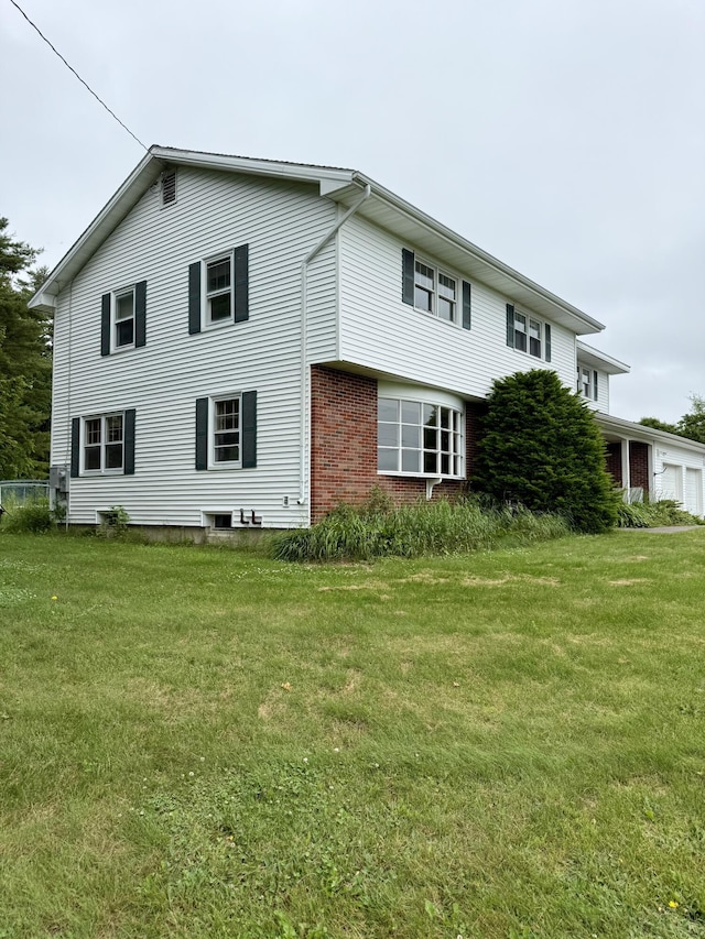 54 Pine Ledge Rd, Bangor, ME 04401 - view of side of home with a yard, a garage, and brick siding