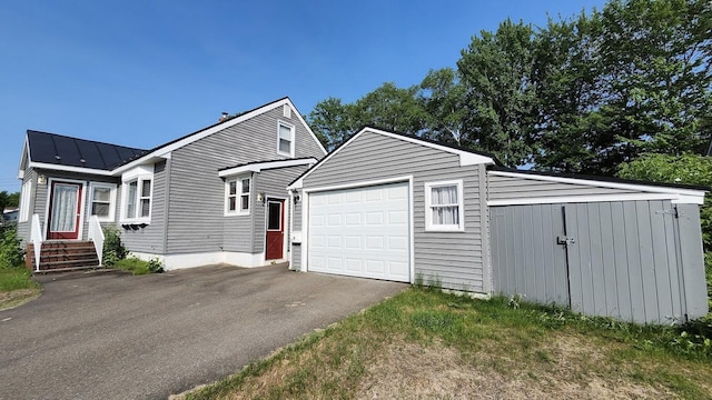 177 Ohio St, Millinocket, ME 04462 - view of front of home featuring driveway, a metal roof, and a standing seam roof