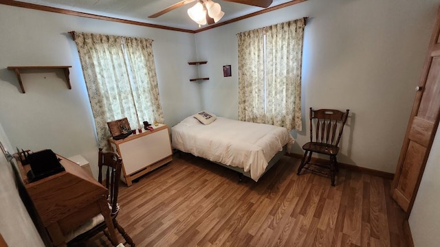 177 Ohio St, Millinocket, ME 04462 - bedroom featuring multiple windows, ornamental molding, wood finished floors, and a baseboard radiator