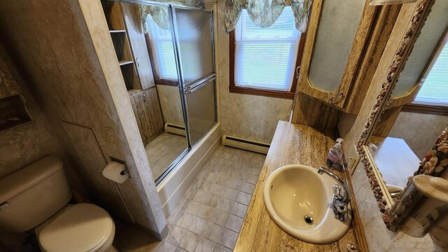 177 Ohio St, Millinocket, ME 04462 - bathroom featuring baseboard heating, a baseboard radiator, vanity, shower / bath combination with glass door, and tile patterned flooring