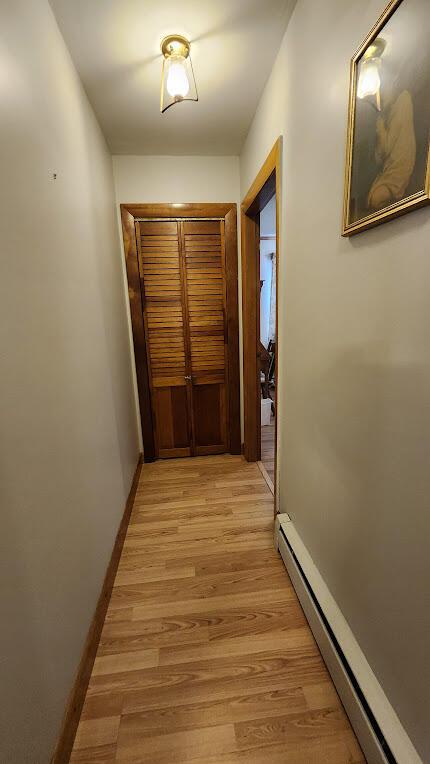 177 Ohio St, Millinocket, ME 04462 - hall with baseboard heating and light wood-style flooring