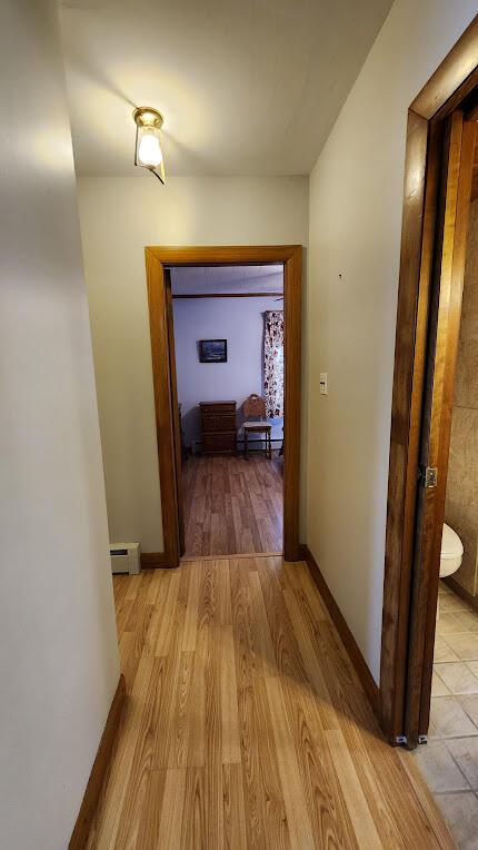 177 Ohio St, Millinocket, ME 04462 - hall featuring light wood-style floors and baseboard heating