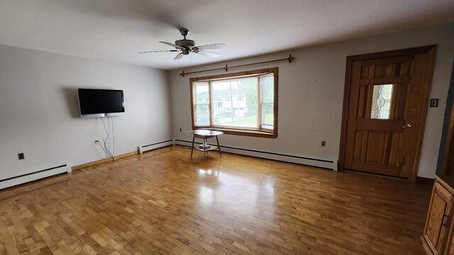 177 Ohio St, Millinocket, ME 04462 - unfurnished living room featuring wood finished floors, a ceiling fan, and a baseboard heating unit