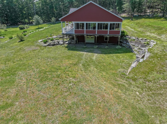 172 Hoxie Hill Rd, Orrington, ME 04474 - back of property featuring a deck, a lawn, and a sunroom