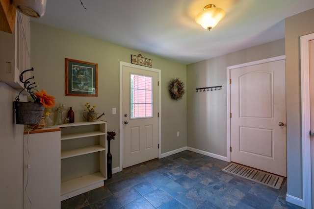 172 Hoxie Hill Rd, Orrington, ME 04474 - foyer featuring baseboards and dark stone finish floors