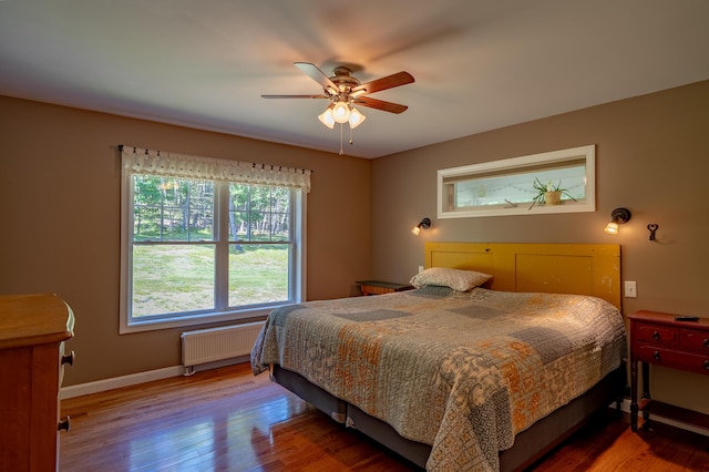 172 Hoxie Hill Rd, Orrington, ME 04474 - bedroom featuring radiator heating unit, wood finished floors, and a ceiling fan