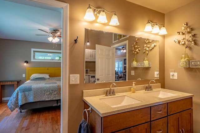 172 Hoxie Hill Rd, Orrington, ME 04474 - full bathroom featuring a ceiling fan, ensuite bath, double vanity, and wood finished floors