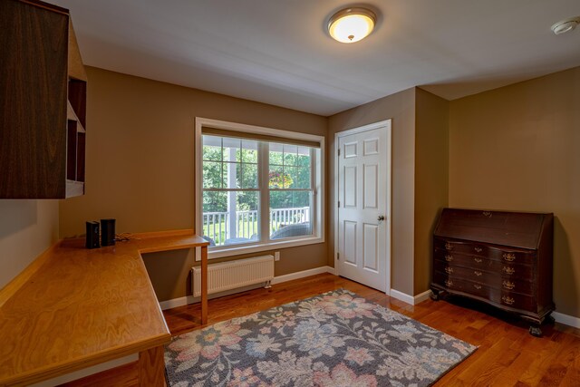 172 Hoxie Hill Rd, Orrington, ME 04474 - office area featuring radiator heating unit and wood finished floors
