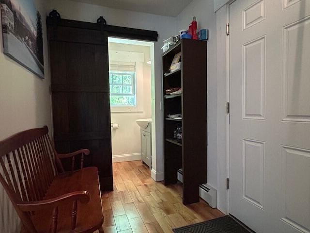 453 Canton Rd, Livermore, ME 04253 - hall featuring light wood-type flooring and a baseboard radiator