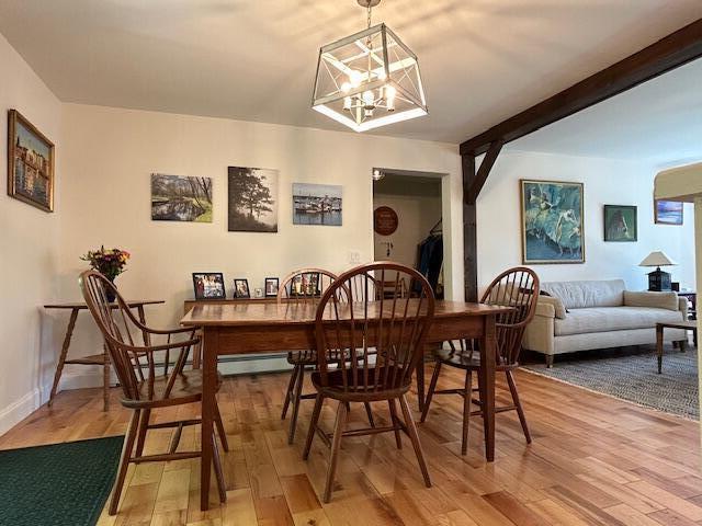453 Canton Rd, Livermore, ME 04253 - dining area featuring light wood-style flooring and a chandelier