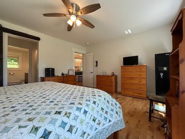 453 Canton Rd, Livermore, ME 04253 - bedroom featuring light wood-style floors and ceiling fan