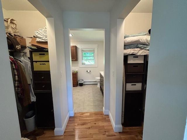 453 Canton Rd, Livermore, ME 04253 - corridor with light wood-type flooring and a baseboard heating unit