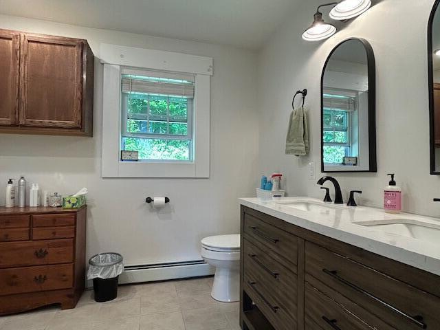 453 Canton Rd, Livermore, ME 04253 - full bath with baseboard heating, double vanity, toilet, and tile patterned floors