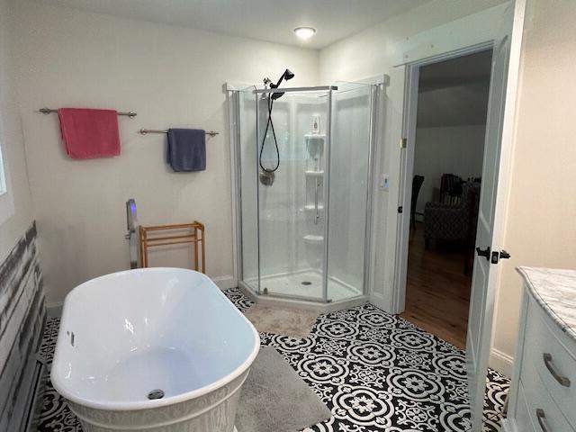 453 Canton Rd, Livermore, ME 04253 - full bathroom with a stall shower, vanity, and a freestanding bath