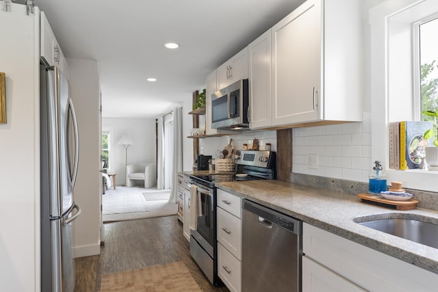140 New Meadows Rd, West Bath, ME 04530 - kitchen with appliances with stainless steel finishes, dark wood-type flooring, white cabinets, recessed lighting, and tasteful backsplash