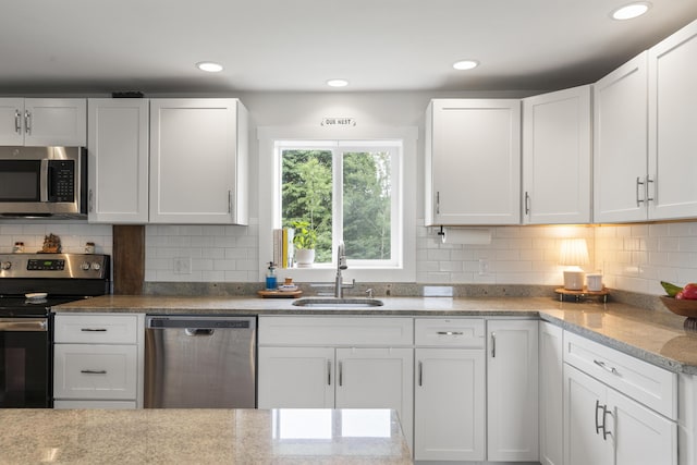 140 New Meadows Rd, West Bath, ME 04530 - kitchen featuring appliances with stainless steel finishes, white cabinets, light stone countertops, and recessed lighting