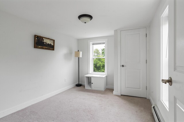 140 New Meadows Rd, West Bath, ME 04530 - unfurnished bedroom featuring a baseboard heating unit and light colored carpet