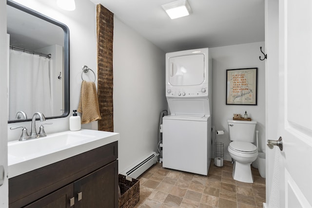 140 New Meadows Rd, West Bath, ME 04530 - bathroom featuring stacked washer and clothes dryer, a baseboard heating unit, stone finish flooring, and vanity