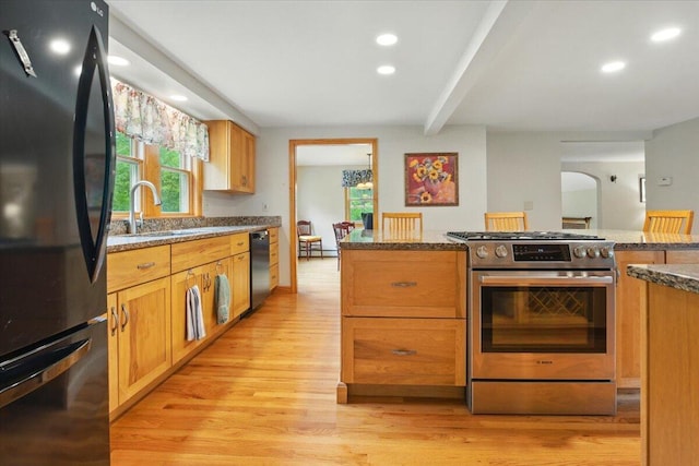 463 Cobbs Bridge Rd, New Gloucester, ME 04260 - kitchen with appliances with stainless steel finishes, light wood-style flooring, plenty of natural light, dark stone countertops, and beam ceiling