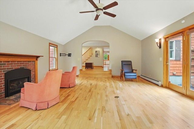 463 Cobbs Bridge Rd, New Gloucester, ME 04260 - living room featuring a baseboard radiator, hardwood / wood-style floors, a ceiling fan, a fireplace, and lofted ceiling