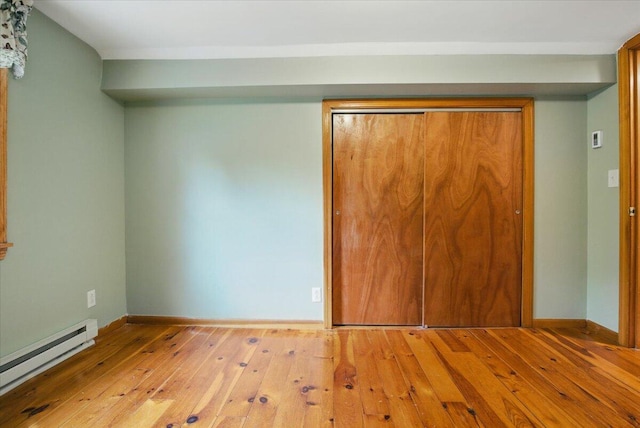 463 Cobbs Bridge Rd, New Gloucester, ME 04260 - unfurnished bedroom with baseboard heating, hardwood / wood-style flooring, and a closet