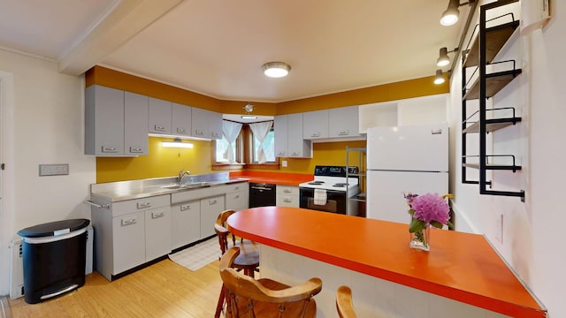 31 Vivian St, Auburn, ME 04210 - kitchen with freestanding refrigerator, range with electric cooktop, stainless steel countertops, light wood finished floors, and black dishwasher
