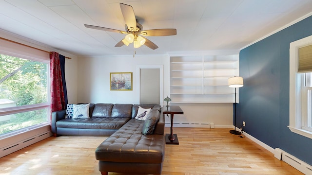 31 Vivian St, Auburn, ME 04210 - living area with a baseboard radiator, plenty of natural light, wood-type flooring, and ornamental molding
