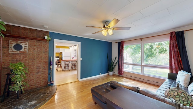 31 Vivian St, Auburn, ME 04210 - living area with a baseboard radiator, a ceiling fan, hardwood / wood-style floors, and crown molding