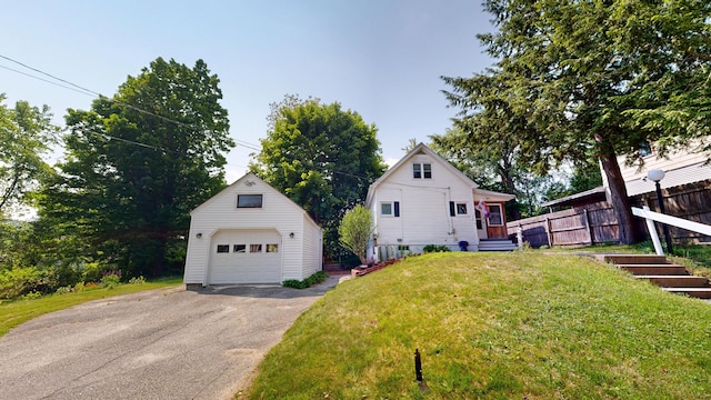 31 Vivian St, Auburn, ME 04210 - view of home's exterior featuring a detached garage, an outdoor structure, and driveway