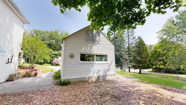 31 Vivian St, Auburn, ME 04210 - view of property exterior with a lawn and a patio area
