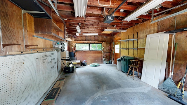 31 Vivian St, Auburn, ME 04210 - garage with a garage door opener and wooden walls