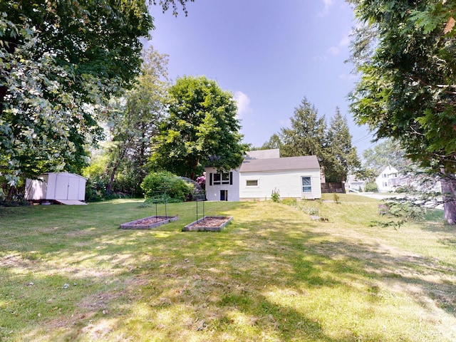31 Vivian St, Auburn, ME 04210 - view of grassy yard featuring a shed