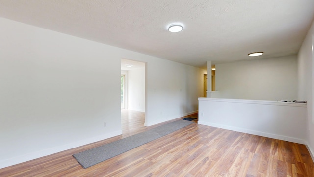 1 Barker St, Jay, ME 04239 - unfurnished room featuring light wood-style flooring and a textured ceiling