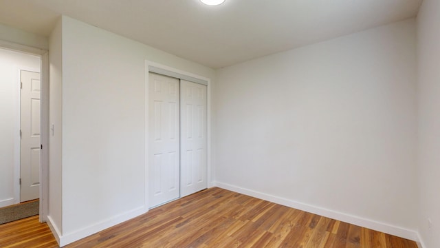 1 Barker St, Jay, ME 04239 - unfurnished bedroom with light wood finished floors and a closet