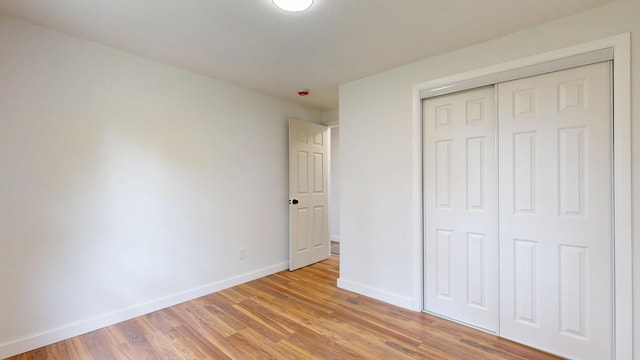 1 Barker St, Jay, ME 04239 - unfurnished bedroom featuring light wood finished floors and a closet