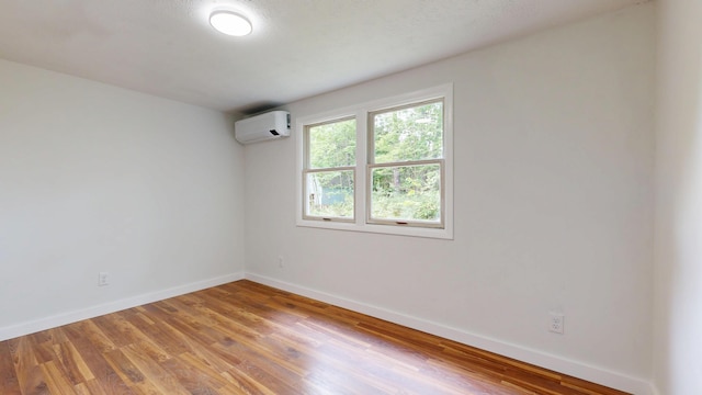 1 Barker St, Jay, ME 04239 - spare room with a wall mounted AC and light wood-style floors